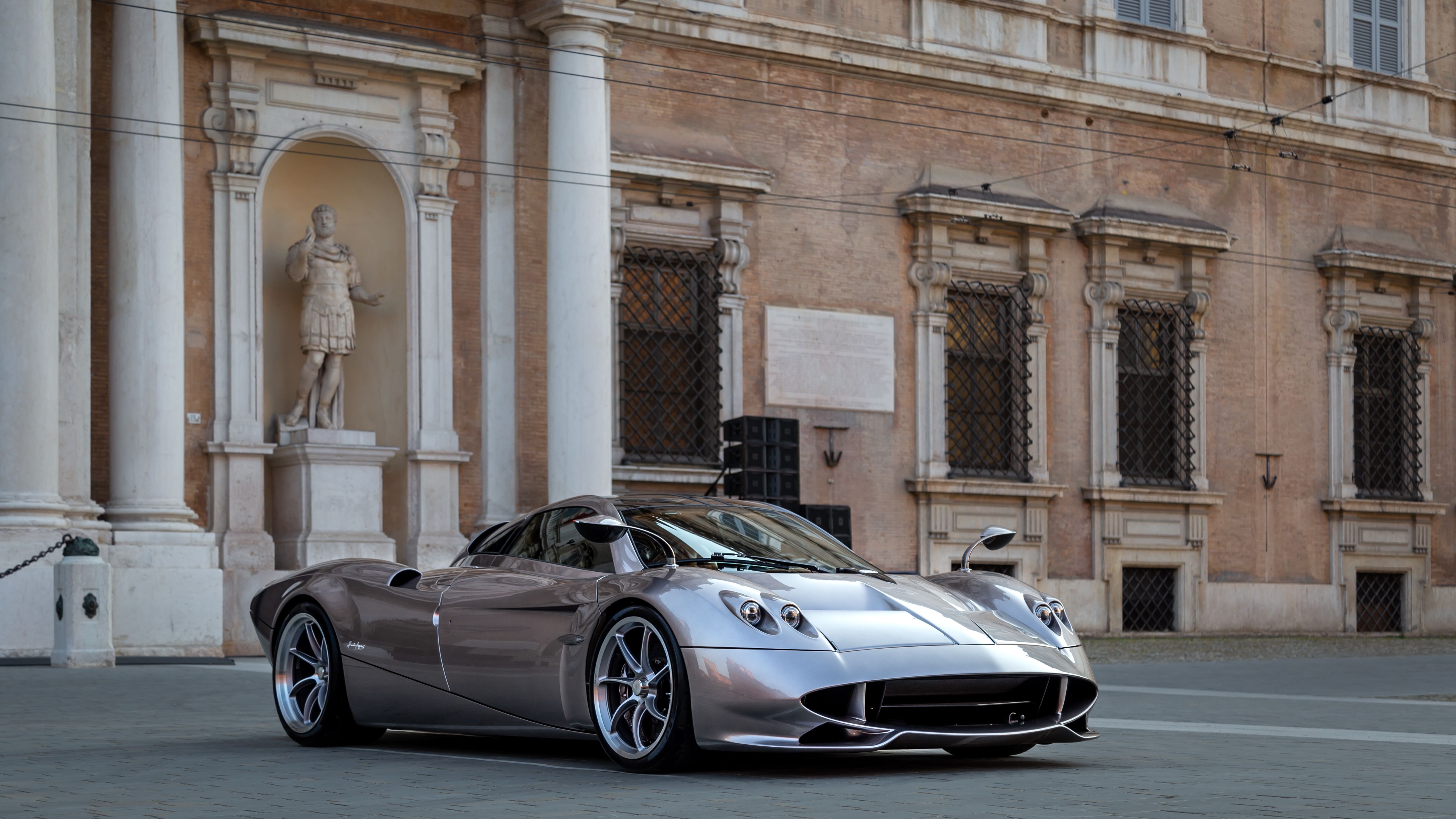 Silver Pagani Huayra Codalunga front three-quarter view in a Modena piazza